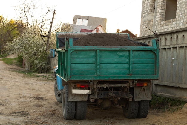 A truck full with black soil for the garden