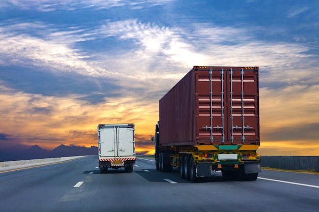 Truck on highway road with red container, transportation concept.