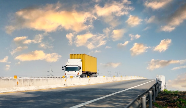 Truck on highway road with yellow container, transportation\
concept.,import,export logistic industrial transporting land\
transport on the expressway