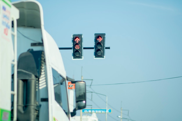 Truck parked next to a red light traffic light.