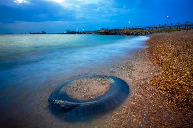 Truck tire and sea scape at dusk