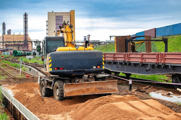 Photo a truck transporting a bulldozer excavator on its flatbed moving along a road