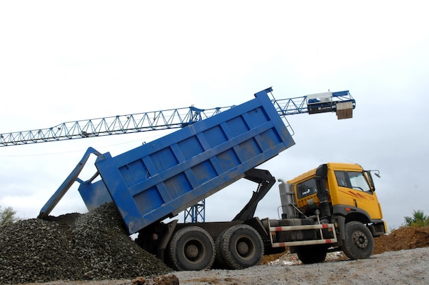 Truck unloads building material in construction