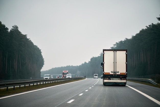 truck with container on the highway cargo transportation concept a big truck moves on the highway concept of shipping company branding