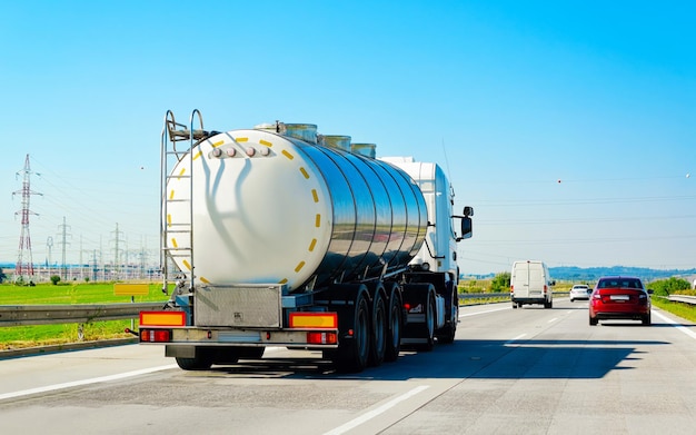 Truck with liquid or oil storage in road or highway of Poland. Lorry with service tanker cistern at logistics work. Semi trailer tank. Cargo car drive. Freight delivery. Transport export industry