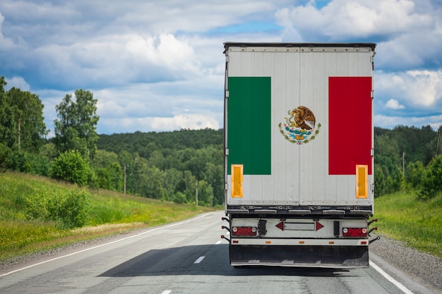 A  truck with the national flag of Mexico depicted on the back door
