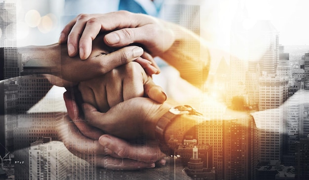 Trust and support Cropped shot of a group of unrecognizable businesspeople sitting in the boardroom with their hands in a huddle