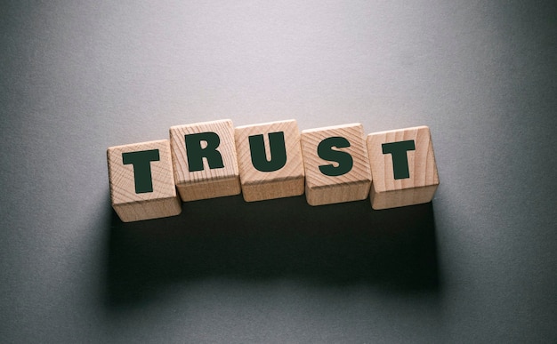trust word written on wooden cubes