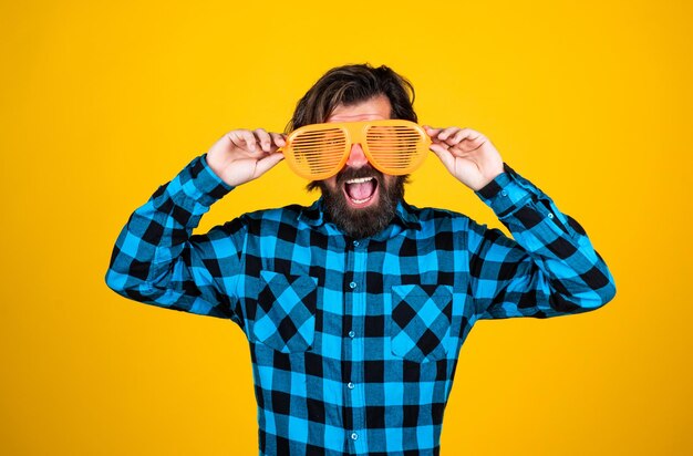 Try on a new style funny and joyful man wear checkered shirt just having fun happy brutal party goer mature bearded hipster in good mood fashion concept trendy man in funny party glasses