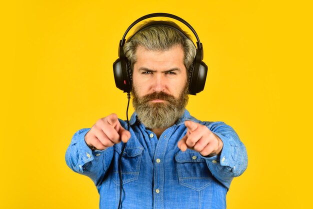 Try this Listening to music Time to relax brutal hipster wear earphone singing and dancing Enjoying his favorite music Man listening music with his headphones bearded man hipster in headset