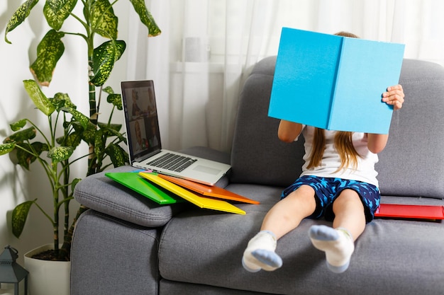 Trying new technologies. Little schoolgirl wearing big VR glasses being impressed playing virtual games. Home school, online education, home education, quarantine concept - Image