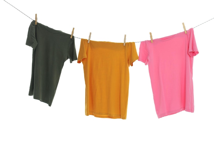 Photo tshirts hanging on twine isolated on white background
