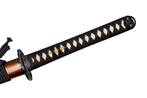 Manico tsuka della spada giapponese avvolta da un cordone di seta nero su pelle di raggio bianca isolata su sfondo bianco messa a fuoco selettiva