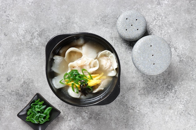 Tteok Mandu Guk is korean Rice Cake Soup with Dumplings in Beef Broth.