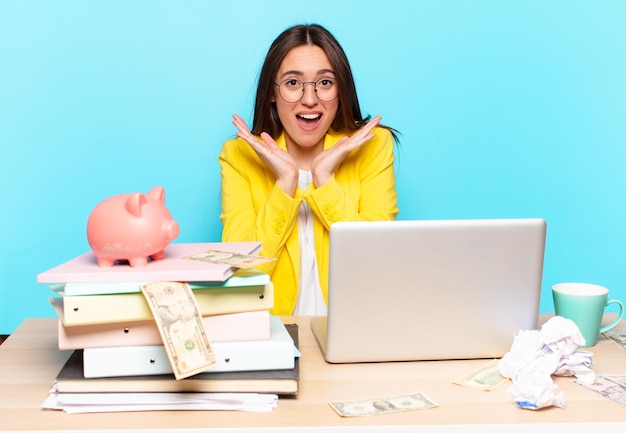 Tty businesswoman sitting on her desk working with a laptop