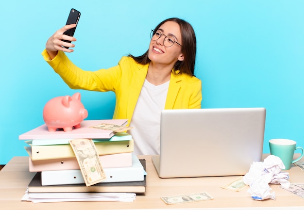 Tty businesswoman sitting on her desk working with a laptop