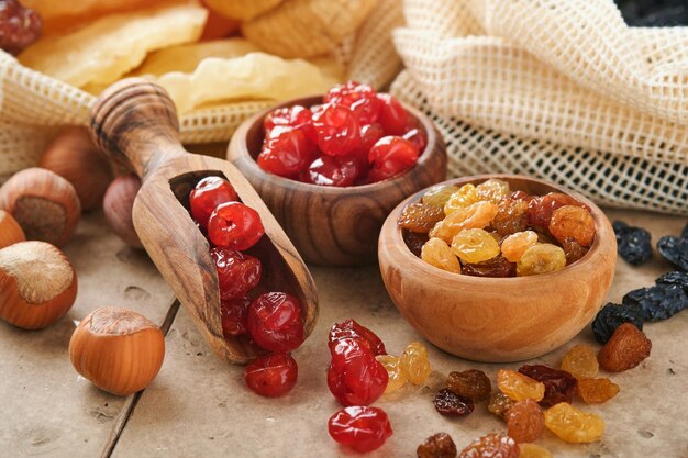 Tu Bishvat celebration concept Mix of dry fruits and almonds hazelnuts walnuts apricots prunes cherries raisins dates apples figs on old tile table background Jewish holiday new year of trees