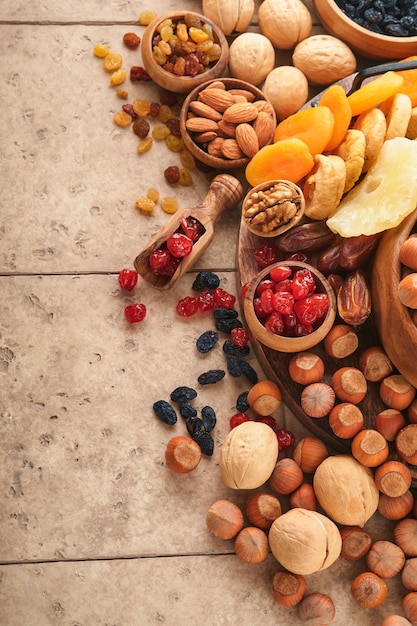 Tu Bishvat viering concept Mix van droge vruchten en noten amandelen hazelnoten walnoten abrikozen pruimen kersen rozijnen dadels appels vijgen over houten tafel Joodse feestdag nieuwjaar van bomen