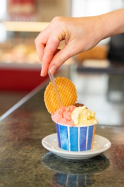 A tub of ice cream in two flavors and a cookie