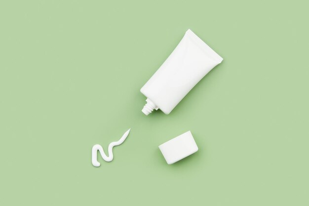 A tube of cream on a green background skinimalism natural skincare