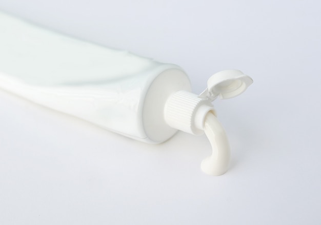 Photo tube of toothpaste or cream on white background.