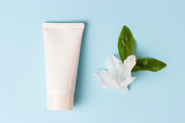 A tube with cream on a blue background front view cosmetics care concept