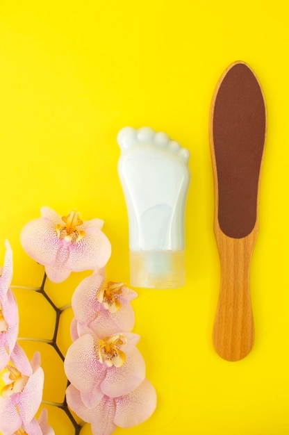 Tubecontainer for cosmetic foot cream Concept of natural cosmetics and skin care Set of pedicure tools Studio shot with copy space empty unfilled Vertical photo