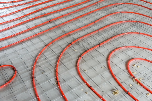 Tubes of the underfloor heating system on a styrofoam insulation