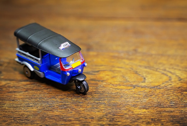  tuk tuk taxi toy on wood table