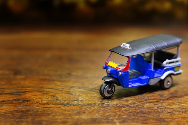  tuk tuk taxi toy on wood table 