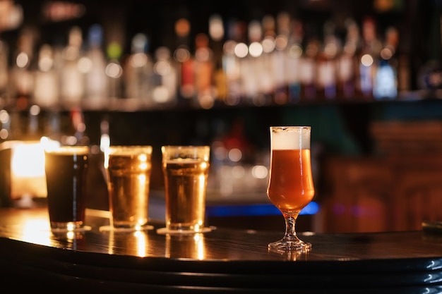 Tulip glass with unfiltered draft beer on bar counter