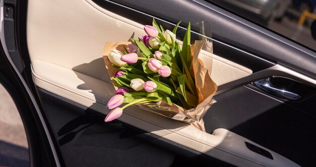 Photo tulips bouquet in car door