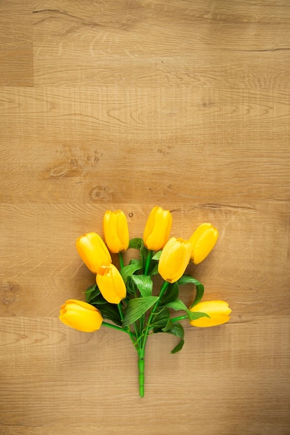 Tulips bunch on wooden background