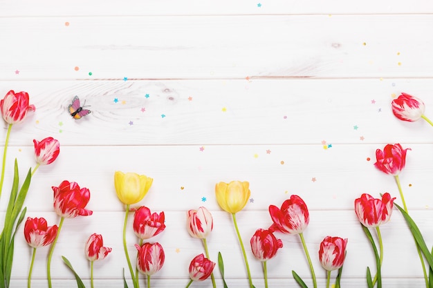 Tulips flowers in wooden background.