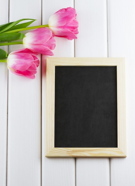 Tulips with empty blackboard