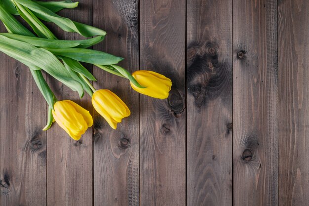 Tulips on wooden table