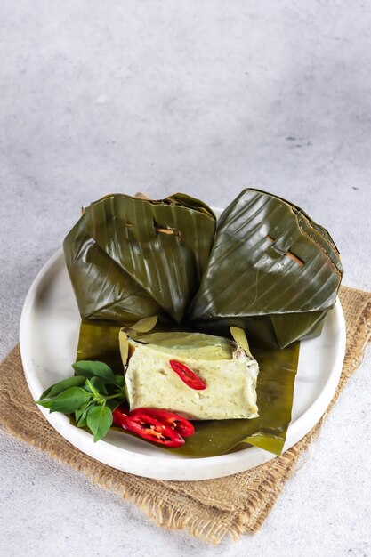 Tum Ayam or gadon ayam botok steamed minced chicken with herb spices wrapped with banana leaf