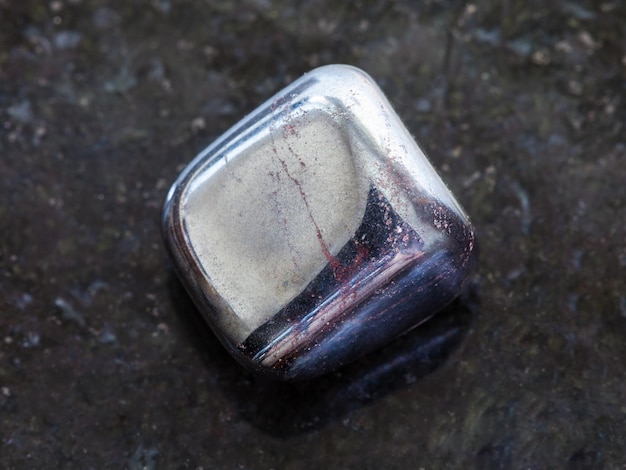 Tumbled hematite stone on dark background