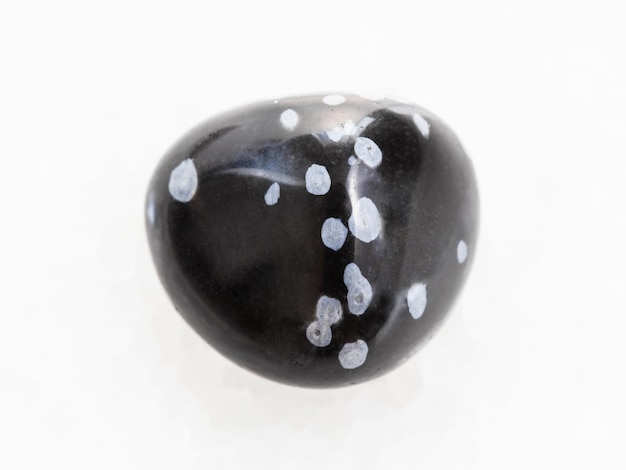 Tumbled snowflake obsidian gemstone on white