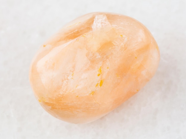 Tumbled Stilbite gemstone on white