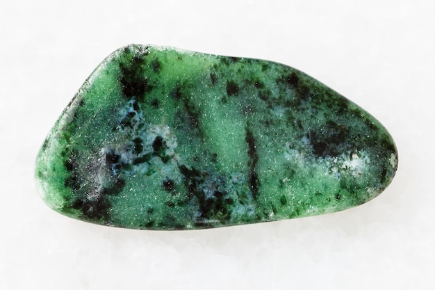 Tumbled zoisite gemstone on white