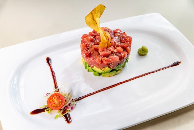 Tuna and avocado tartare on a white plate