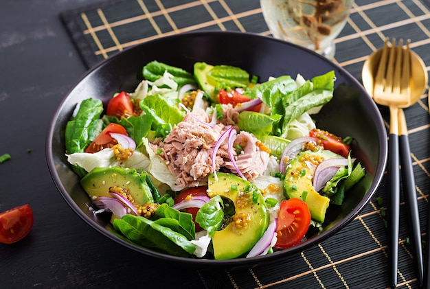 Tuna fish salad with lettuce, cherry tomatoes, avocado and red onions. Healthy food. French cuisine.