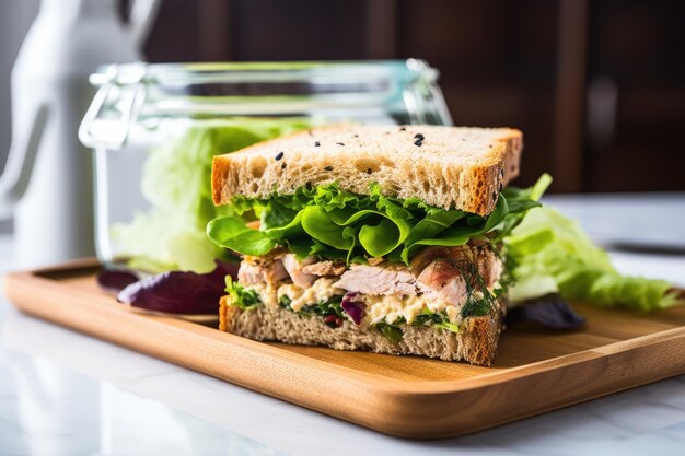 Photo a tuna and lettuce sandwich under a glass cover