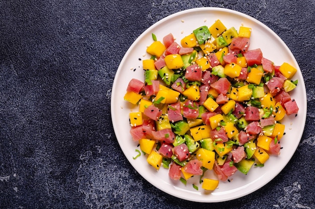 Tuna mango avocado salad tartare served with green onions and sesame seeds