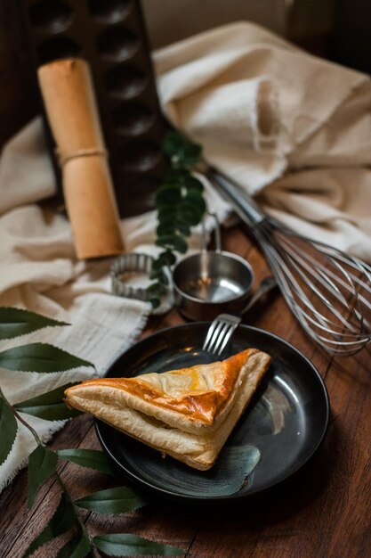 tuna pie with ceramic plate on a wooden table