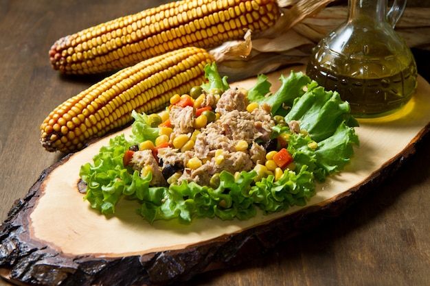 tuna salad with mais on wood board