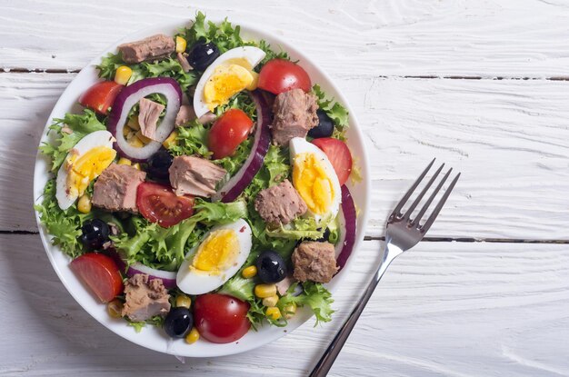 Tuna salad with tomatoes olives eggs and onion