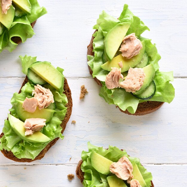 Photo tuna sandwiches with avocado and lettuce leaves