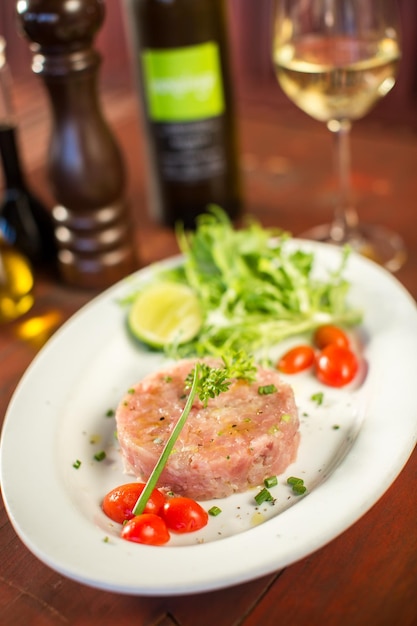 Tuna tartare with vegetables in a restaurant